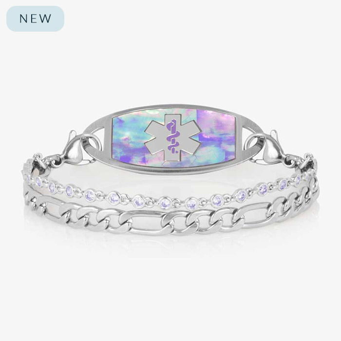Women's medical ID bracelet with iridescent lavender opal inlay tag and light purple crystal accents on a double silver chain, engraved with the medical alert symbol.