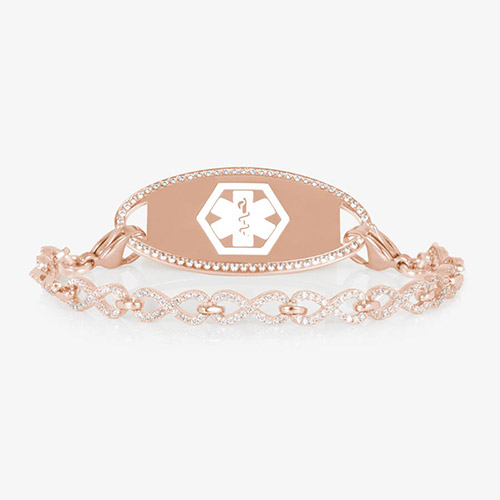 Rose gold medical ID bracelet with a CZ-framed tag engraved with a white medical symbol, paired with a rose gold chain of linked infinity shapes covered in sparkling clear crystals.