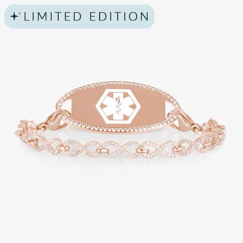 Rose gold medical ID bracelet with a CZ-framed tag engraved with a white medical symbol, paired with a rose gold chain of linked infinity shapes covered in sparkling clear crystals.