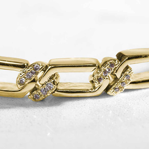 Close-up view of the Harper Gold bracelet’s rectangular chain links featuring sparkling cubic zirconia accents, showcasing its intricate gold-plated detailing.