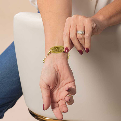 Back view of the Harper Gold medical ID bracelet on a model’s wrist, highlighting the custom-engraved gold tag with emergency medical information.