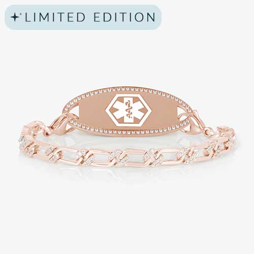 Rose gold medical alert bracelet with a crystal-accented link chain and a polished medical ID tag framed in clear CZs, displayed on a white background.