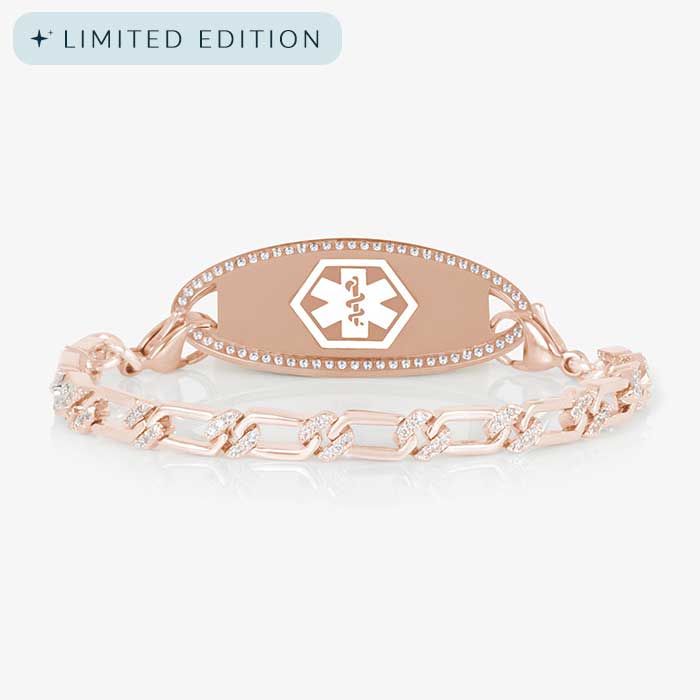 Rose gold medical alert bracelet with a crystal-accented link chain and a polished medical ID tag framed in clear CZs, displayed on a white background.