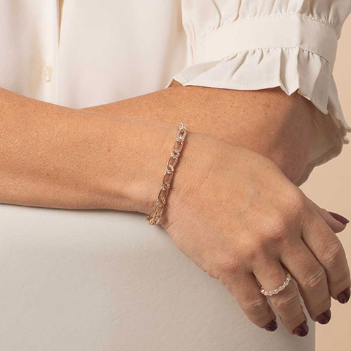 Side view of the Harper Rose medical ID bracelet worn on the wrist, showcasing its slim rose gold links and matching CZ-accented ring.