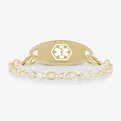Jovie Medical ID bracelet in gold with clear CZs and an oval gold ID tag bordered with crystals, featuring a white medical symbol.