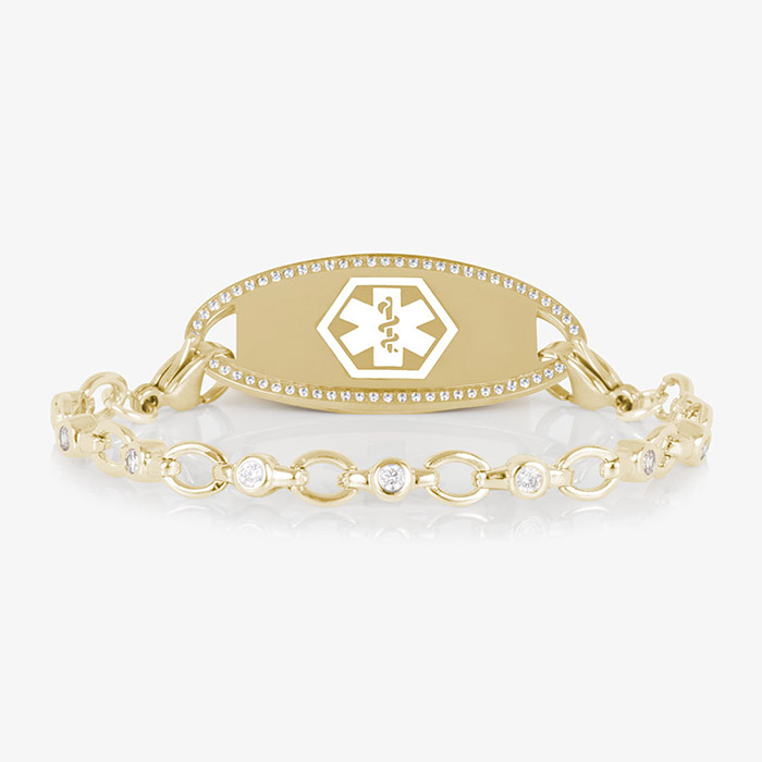 Jovie Medical ID bracelet in gold with clear CZs and an oval gold ID tag bordered with crystals, featuring a white medical symbol.