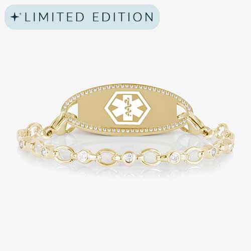 Jovie Medical ID bracelet in gold with clear CZs and an oval gold ID tag bordered with crystals, featuring a white medical symbol.