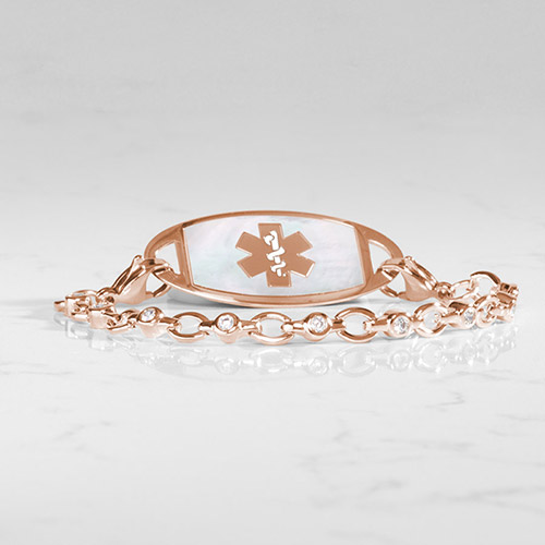 Rose gold medical ID bracelet with clear CZ accents and a mother-of-pearl inlay featuring a rose gold medical symbol.