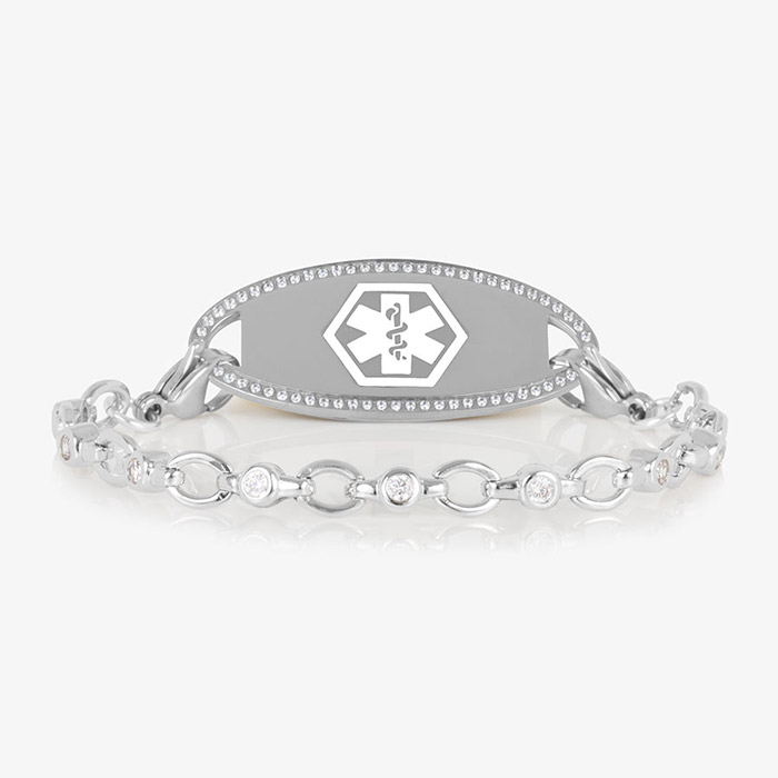 Jovie Medical ID bracelet in silver with clear CZs and an oval silver ID tag bordered with crystals, featuring a white medical symbol.