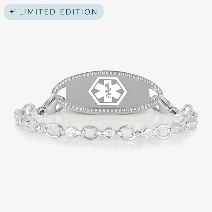 Jovie Medical ID bracelet in silver with clear CZs and an oval silver ID tag bordered with crystals, featuring a white medical symbol.
