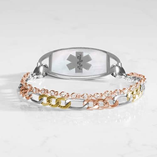 Silver-tone medical ID bracelet with a mother-of-pearl emblem plate, crystal chain detail, and mixed-metal links in gold and rose gold.