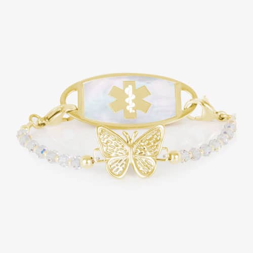 Gold-tone butterfly medical ID bracelet with iridescent crystal beads and a mother-of-pearl emblem plate, blending safety and elegance.