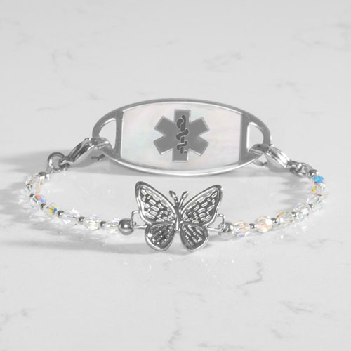 Silver medical alert bracelet paired with a mother-of-pearl ID tag featuring the Star of Life symbol and crystal butterfly design.
