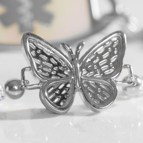 Close-up of the Monarch bracelet's silver butterfly centerpiece accented by shimmering crystal beads and polished metal details.