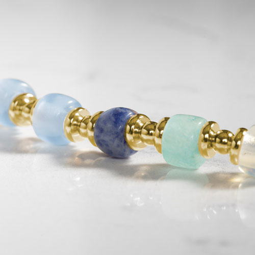 Close-up of the Selene bracelet showcasing blue and aqua beads with polished gold-tone spacers for a refined look.