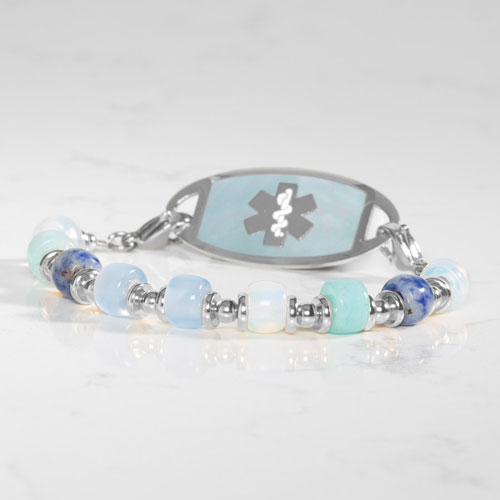 Silver-tone medical ID bracelet paired with blue and aqua beaded Selene strands and a mother-of-pearl alert tag with Star of Life.