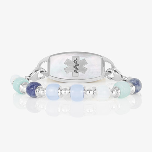Silver-tone medical alert bracelet with mother-of-pearl inlay and Star of Life emblem, paired with a blue beaded Selene bracelet.