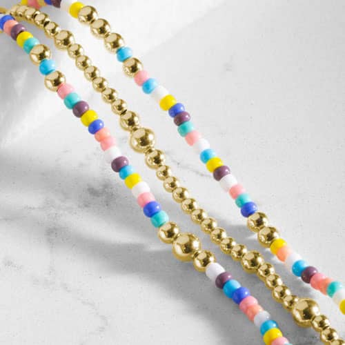 Close-up of the gold tone beaded bracelet with colorful seed beads.