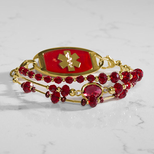 Luxurious Holly Medical ID Bracelet in Gold, featuring three strands of red freshwater pearls and crystals, perfect for pairing with a medical ID tag