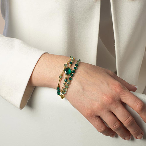 Laurel Crystal and Gold Medical ID Bracelet, shown on wrist, with deep emerald crystals and a gold-set square centerpiece