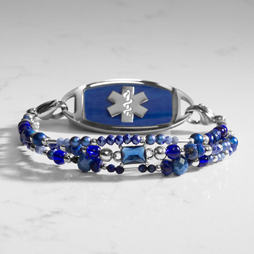 Lapis and blue beaded medical alert bracelet with beautiful lapis inlay medical ID tag on marble background
