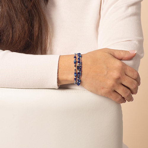 Woman wearing deep blue medical alert bracelet with lapis blue beaded accents