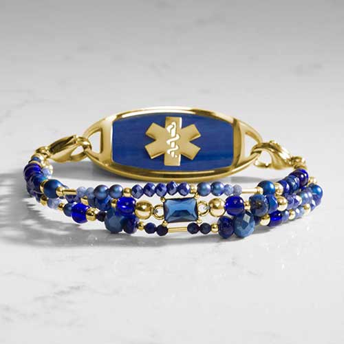 Lapis and blue beaded medical alert bracelet with beautiful lapis inlay medical ID tag on marble background