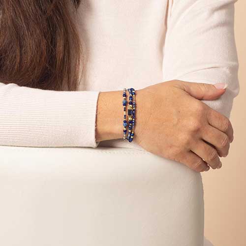 Woman wearing deep blue medical alert bracelet with lapis blue beaded accents