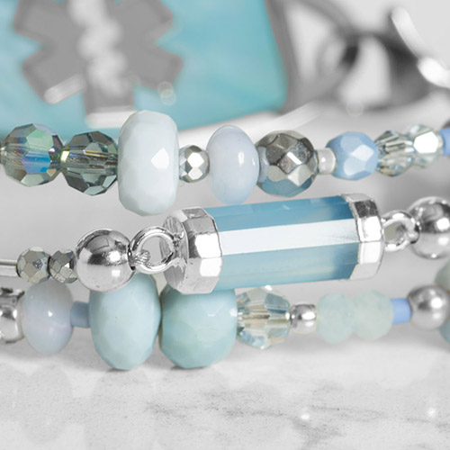 Silver Dewdrop medical ID bracelet displayed flat, showcasing the intricate chain design and polished medical ID tag.