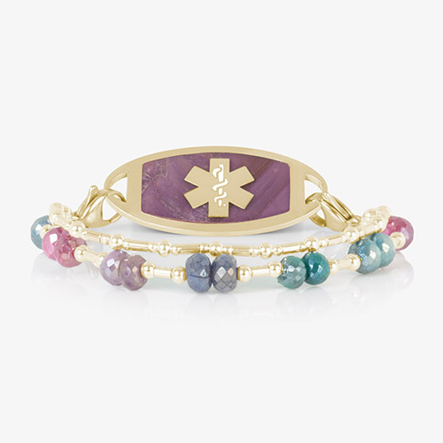 Front-facing view of Lisa bracelet laid flat, with pink-inlay gold ID tag and vibrant double-strand multicolor gemstone band.