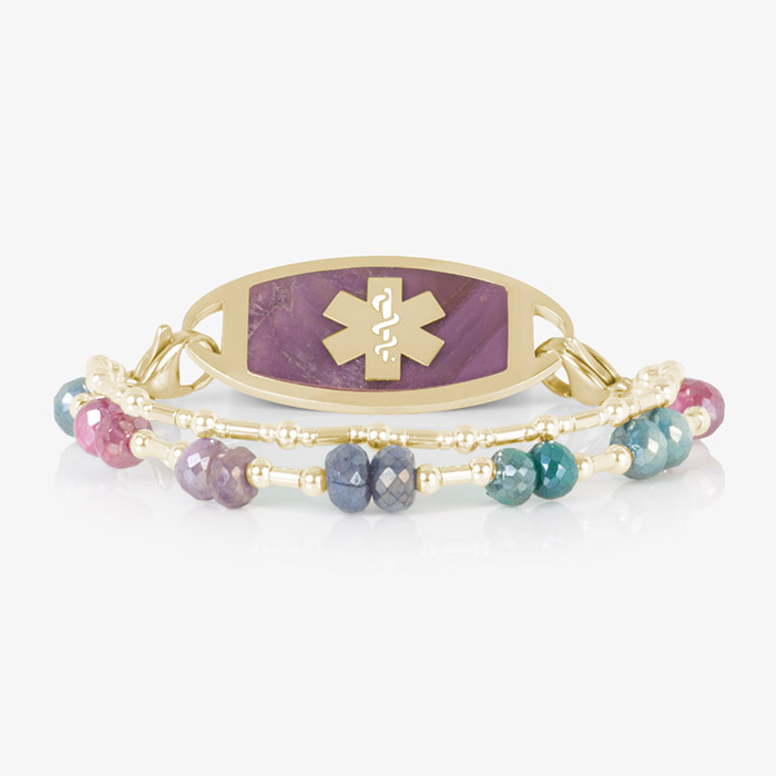 Front-facing view of Lisa bracelet laid flat, with pink-inlay gold ID tag and vibrant double-strand multicolor gemstone band.