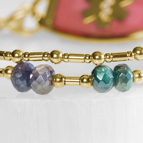 Close-up of Lisa bracelet’s double-strand band, showcasing the faceted green and purple gemstone beads with gold accents.