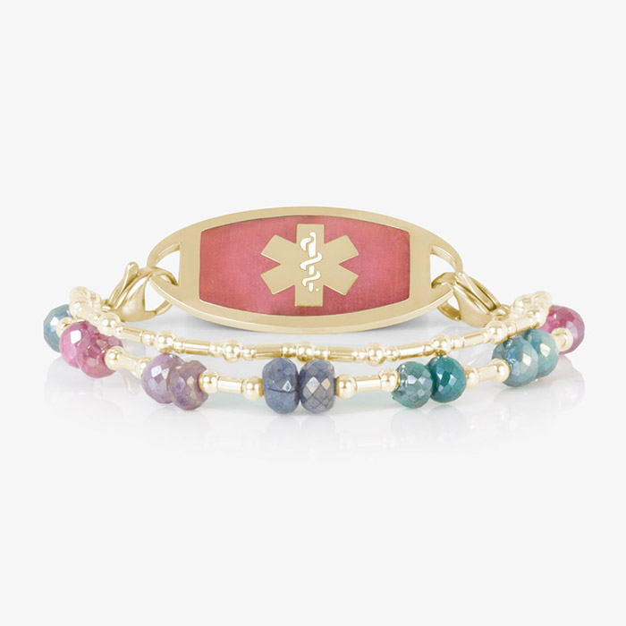 Front-facing view of Lisa bracelet laid flat, with pink-inlay gold ID tag and vibrant double-strand multicolor gemstone band.