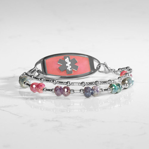 Two Strand bracelet featuring silver filled bead and faceted moonstone crystals, attached to a silver tone medical ID tag featuring warm pink stone inlay and a silver caduceus.