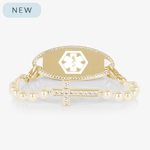 Gold medical ID bracelet with CZ-accented border and cross charm, displayed on a white background