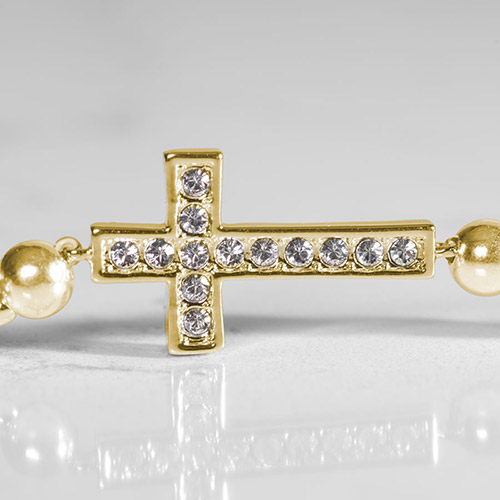 Close-up of gold-plated crystal cross centerpiece on the Faith women's medical alert bracelet, adorned with sparkling CZ stones.