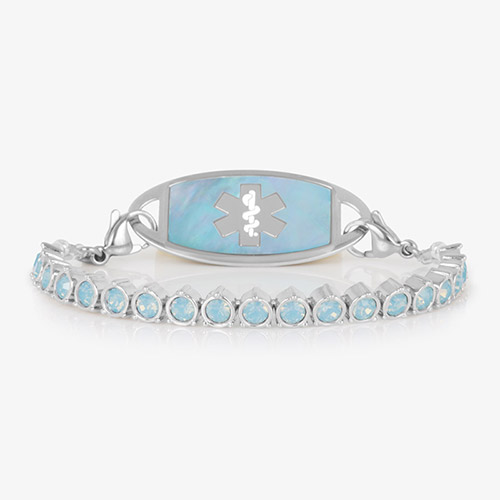 Straight-on product image of a silver medical ID bracelet with iridescent blue opal stones and a matching ID tag featuring a silver medical caduceus symbol.