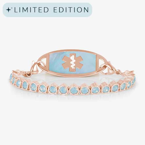 Rose gold medical ID bracelet with opal inlay tag and light blue opal crystal links, shown against a white background.