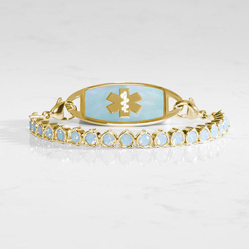 Front view of gold and blue opal medical ID bracelet featuring a matching ID tag with gold emblem