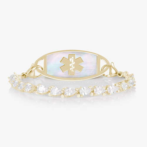 Elegant women's medical ID bracelet featuring 12k gold plating, pear-cut CZ stones, and a white mother-of-pearl tag with engraved medical symbol.