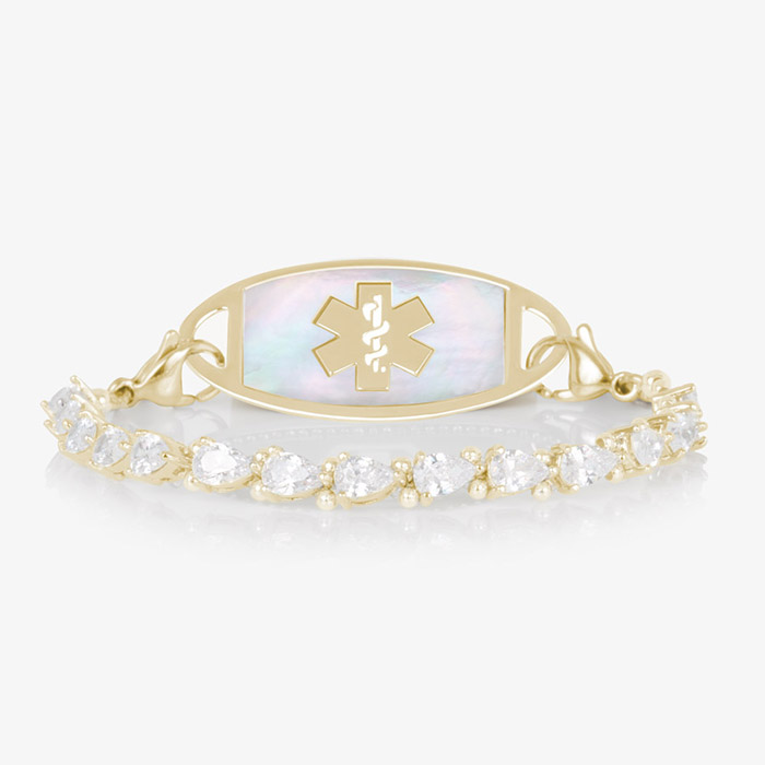 Elegant women's medical ID bracelet featuring 12k gold plating, pear-cut CZ stones, and a white mother-of-pearl tag with engraved medical symbol.