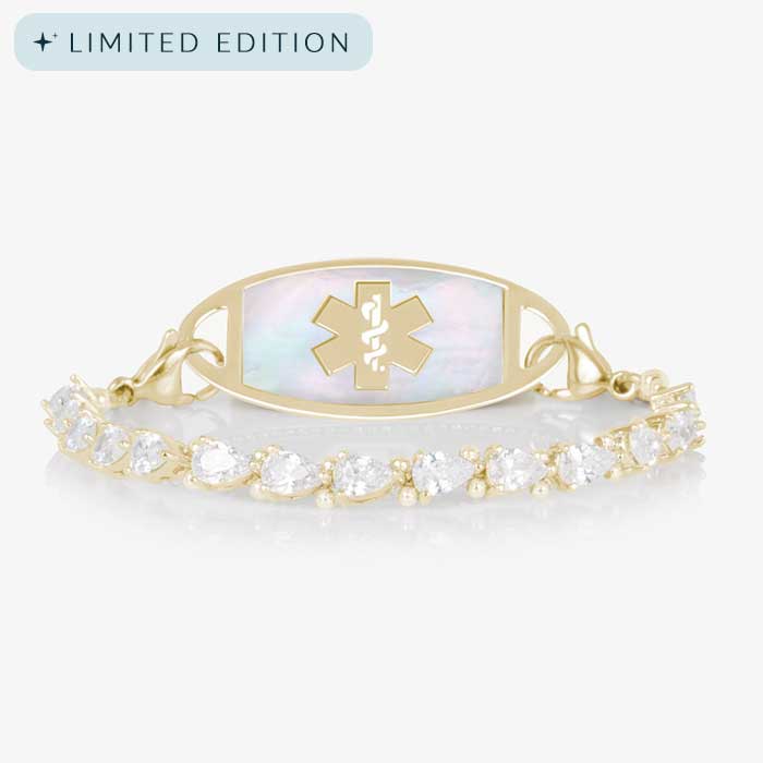 Elegant women's medical ID bracelet featuring 12k gold plating, pear-cut CZ stones, and a white mother-of-pearl tag with engraved medical symbol.