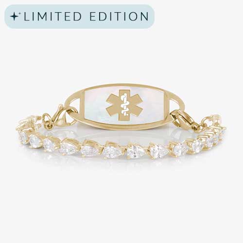 Elegant women&#39;s medical ID bracelet featuring 12k gold plating, pear-cut CZ stones, and a white mother-of-pearl tag with engraved medical symbol.