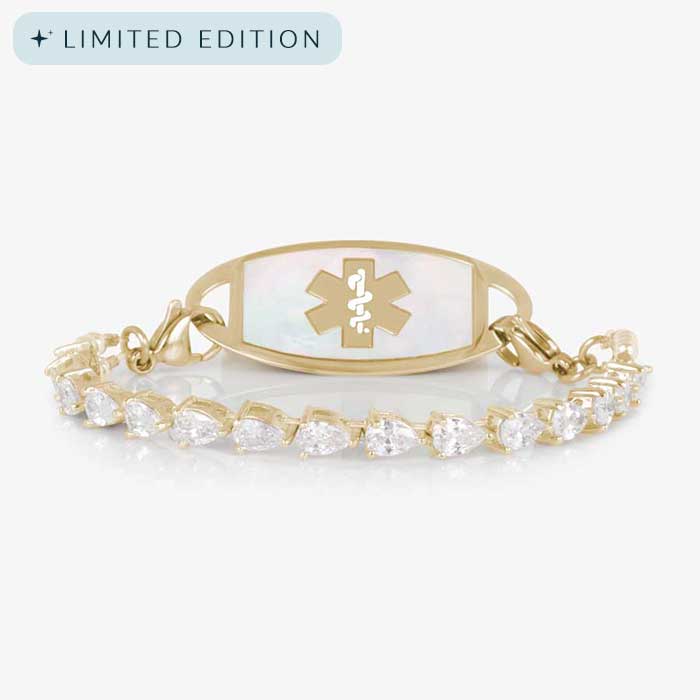 Elegant women's medical ID bracelet featuring 12k gold plating, pear-cut CZ stones, and a white mother-of-pearl tag with engraved medical symbol.
