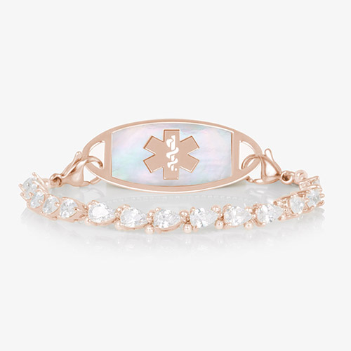 Jackie Rose stretch medical ID bracelet featuring 14k rose gold plating, pear-cut CZs, and a white mother-of-pearl tag with engraved medical symbol, shown on a white background.