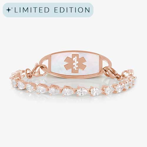 Jackie Rose stretch medical ID bracelet featuring 14k rose gold plating, pear-cut CZs, and a white mother-of-pearl tag with engraved medical symbol, shown on a white background.