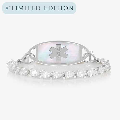 Rhodium-plated stretch medical alert bracelet with pear-cut CZ stones and white mother-of-pearl tag engraved with medical symbol, shown on clean white background.