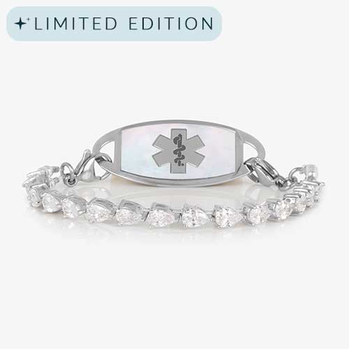 Rhodium-plated stretch medical alert bracelet with pear-cut CZ stones and white mother-of-pearl tag engraved with medical symbol, shown on clean white background.