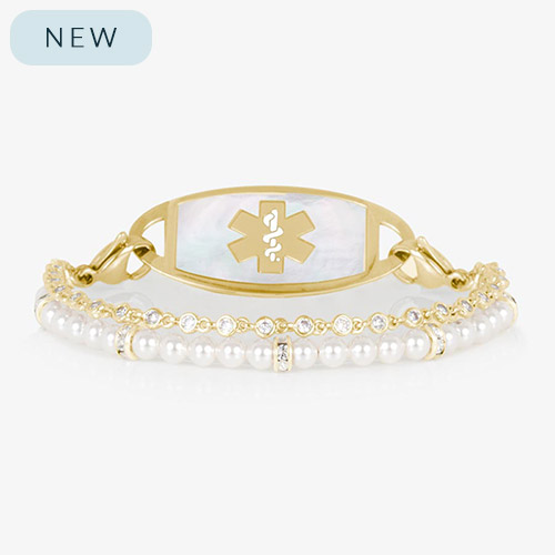 Charlotte Pearl medical ID bracelet in gold finish with a mother-of-pearl tag and gold medical symbol. Features two strands: one of white pearls and one of bezel-set CZ crystals.