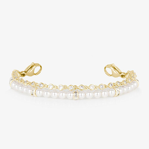 Charlotte Pearl double-strand bracelet in gold featuring a row of classic white pearls accented with gold and CZ rondelles, paired with a line of bezel-set CZ crystals.